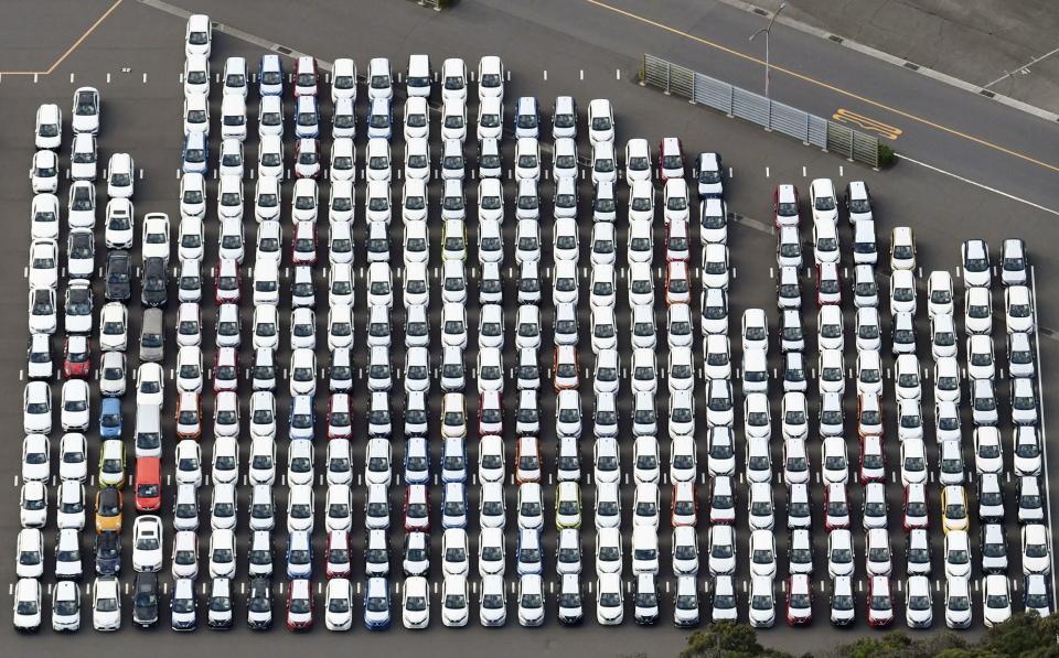 In this Nov. 20, 2018, aerial photo, Nissan Motor cars are seen at the automaker's Oppama plant, in Yokosuka, near Tokyo. Nissan is seeing sales and profits tumble, as its once revered former chairman, Carlos Ghosn, awaits trial on charges of financial misconduct. The Japanese automaker says it is beefing up corporate governance and sticking with its alliance with French partner Renault SA. (Kyodo News via AP)