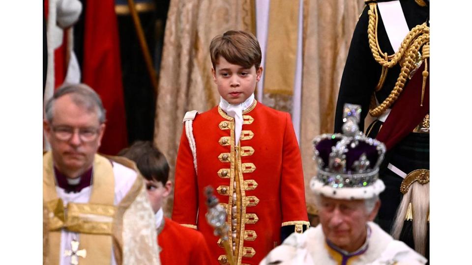 Page of Honour Prince George of Wales and Britain's King Charles III wearing the Imperial state Crown leave Westminster Abbey after the Coronation Ceremonies in central London on May 6, 2023. 