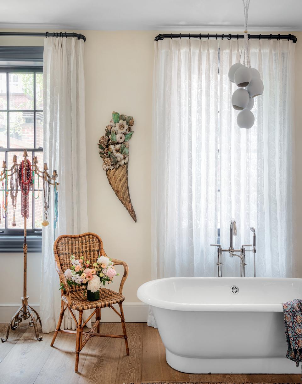 A luxurious bathroom with a large tub and a chair