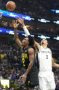 Utah Jazz guard Collin Sexton (2) shoots as San Antonio Spurs center Victor Wembanyama (1) defends during the first half of an NBA basketball game Wednesday, March 27, 2024, in Salt Lake City. (AP Photo/Rick Bowmer)