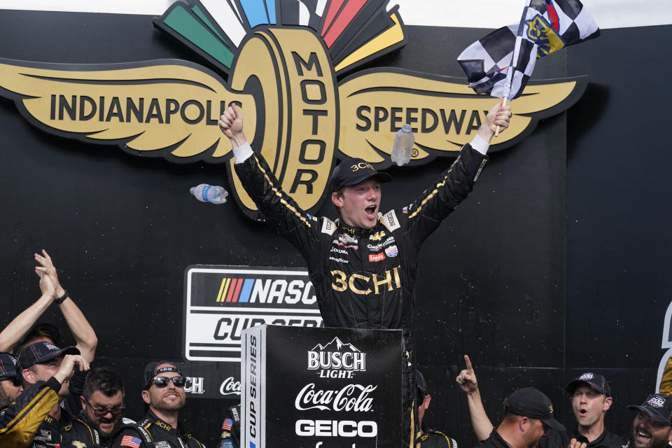 Tyler Reddick celebrates after winning a NASCAR Cup Series auto race at Indianapolis Motor Speedway, Sunday, July 31, 2022, in Indianapolis. (AP Photo/Darron Cummings)