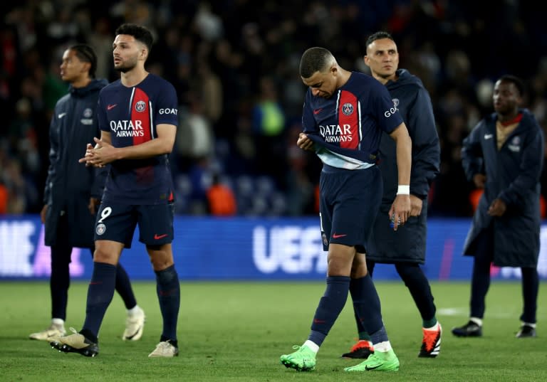 Kylian Mbappe walks off the pitch with PSG teammates after the French side's 3-2 defeat by Barcelona in the first leg of their Champions League quarter-final tie (FRANCK FIFE)