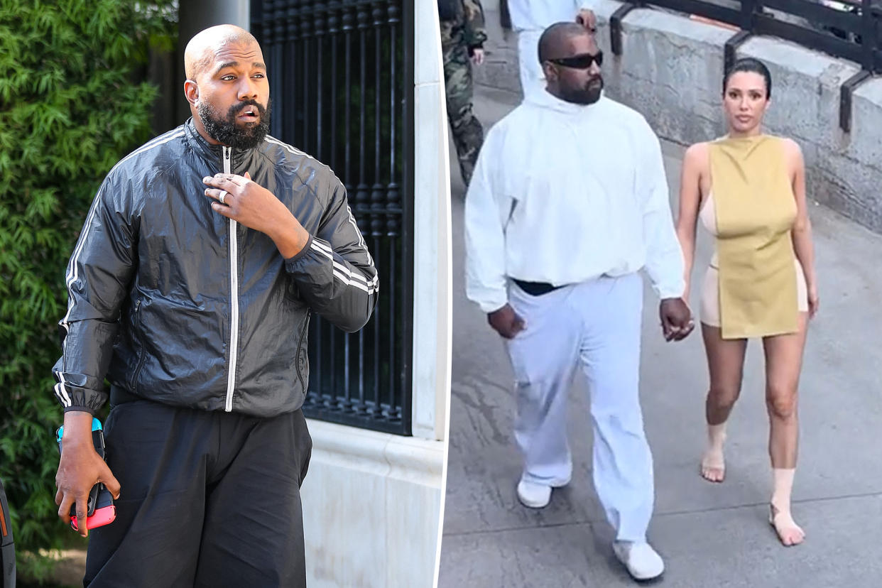 Kanye West and a woman walking on a sidewalk