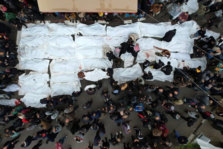 Una vista aérea muestra a los palestinos llorando a sus familiares muertos en un ataque israelí nocturno contra el campo de refugiados de Al-Maghazi, durante un funeral masivo en el hospital Al-Aqsa en Deir Al-Balah, en el sur de la Franja de Gaza, el 25 de diciembre de 2023