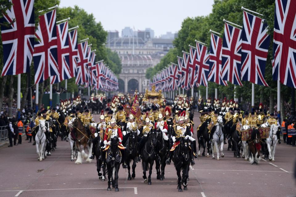 Soldiers parade during the Platinum Jubilee Pageant outside Buckingham Palace in London, Sunday, June 5, 2022, on the last of four days of celebrations to mark the Platinum Jubilee. The pageant will be a carnival procession up The Mall featuring giant puppets and celebrities that will depict key moments from the Queen Elizabeth II's seven decades on the throne. (AP Photo/Frank Augstein, Pool)