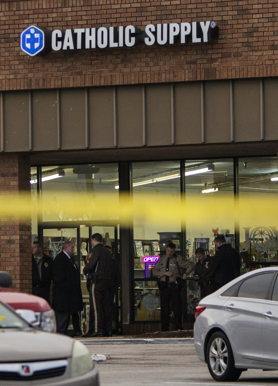 Authorities investigate the scene at a Catholic Supply store where a gunman went into the religious supply store, sexually assaulted at least one woman and shot a woman in the head, Monday, Nov. 19, 2018, in Ballwin, Mo. (Johanna Huckeba/St. Louis Post-Dispatch via AP)