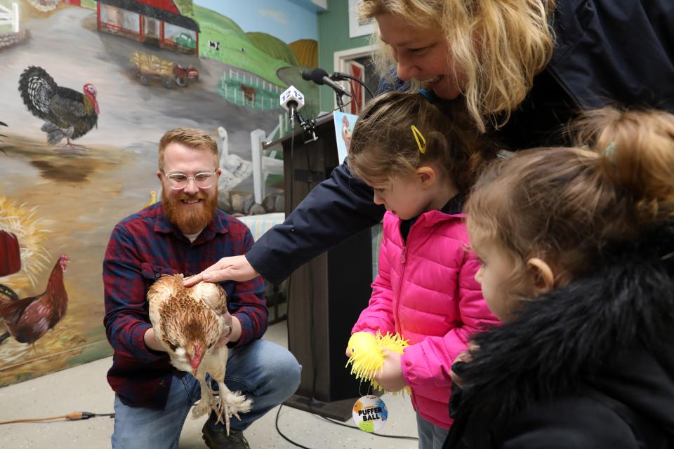 Children and adults greeted Cluxatawney Henrietta, held by Muscoot Farm manager Jonathon Benjamin, after she predicted an early Spring by laying an egg, at Alfred B. DelBello Muscoot Farm in Katonah during a Groundhog Day celebration Feb. 2, 2024.