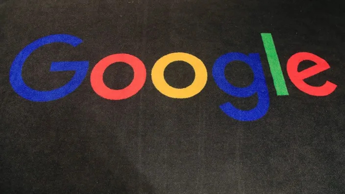 The Google logo is seen against a dark background