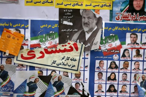 Iranian electoral posters and fliers are pictured on the last day of election campaign in Tehran on February 19