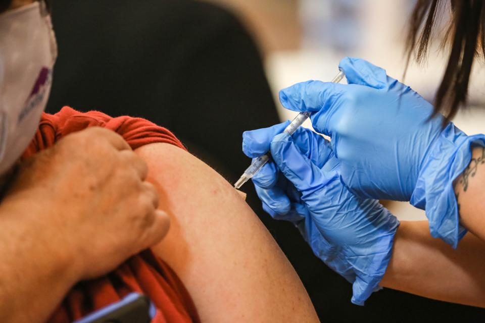 People get a vaccine at a clinic offering COVID-19 vaccinations at the New Mexico Farm & Ranch Heritage Museum in Las Cruces on Tuesday, Oct. 19, 2021.