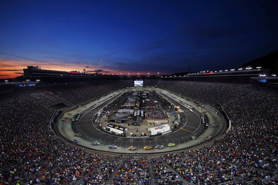 NASCAR Cup Series drivers race during the Bass Pro Shops Night Race at Bristol Motor Speedway.