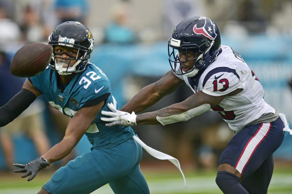 Jacksonville Jaguars cornerback Tyson Campbell (32) can't come up with an interception against Houston Texans wide receiver Brandin Cooks (13) during the fourth quarter Sunday, Dec. 2021 at TIAA Bank Field in Jacksonville. The Jaguars hosted the Texans during a regular season NFL game. Houston defeated Jacksonville 30-16. [Corey Perrine/Florida Times-Union]