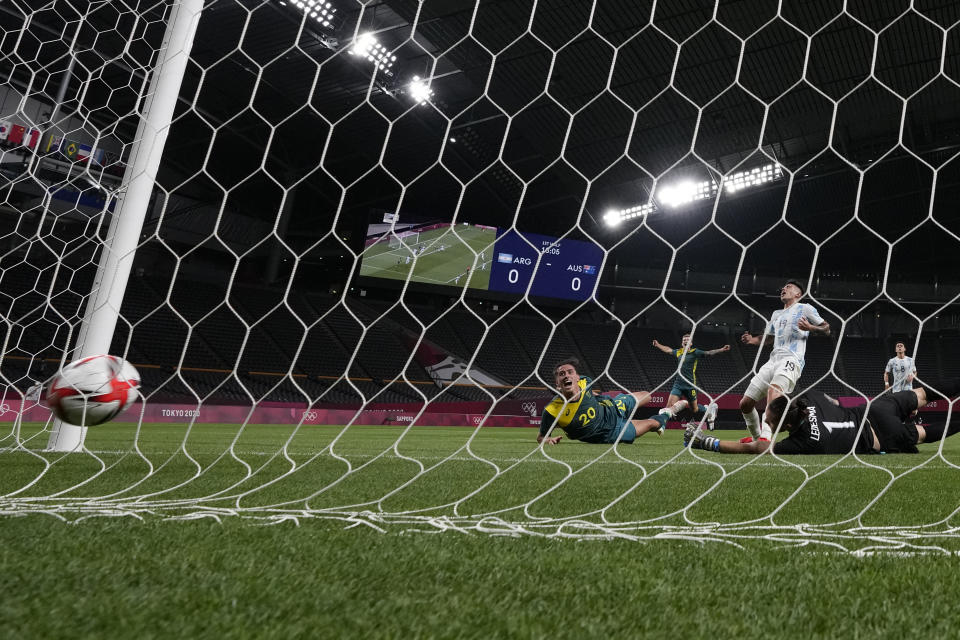 Australia's Lachlan Wales scores his side's opening goal against Argentina during a men's soccer match at the 2020 Summer Olympics, Thursday, July 22, 2021, in Sapporo, Japan. (AP Photo/SIlvia Izquierdo)