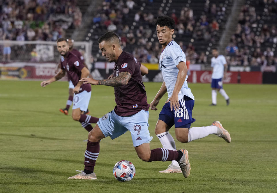 Colorado Rapids forward Andre Shinyashiki, left, moves the ball past FC Dallas midfielder Brandon Servania during the second half of an MLS soccer match Wednesday, July 21, 2021, in Commerce City, Colo. The Rapids won 2-0. (AP Photo/David Zalubowski)