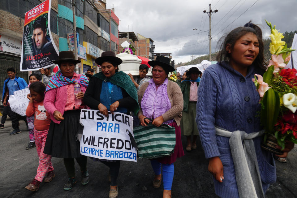 The relatives of 18-year-old Wilfredo Lizarme walk around the city streets with the casket that contains his body, in Andahuaylas, Peru, Tuesday, Dec. 13, 2022. Lizarme is one of the 6 persons that have died during the protests asking for general elections and the resignation of Peru´s new president Dina Boluarte and the Parliament, after an attempted coup by the now former President Pedro Castillo. (AP Photo/Franklin Briceño)
