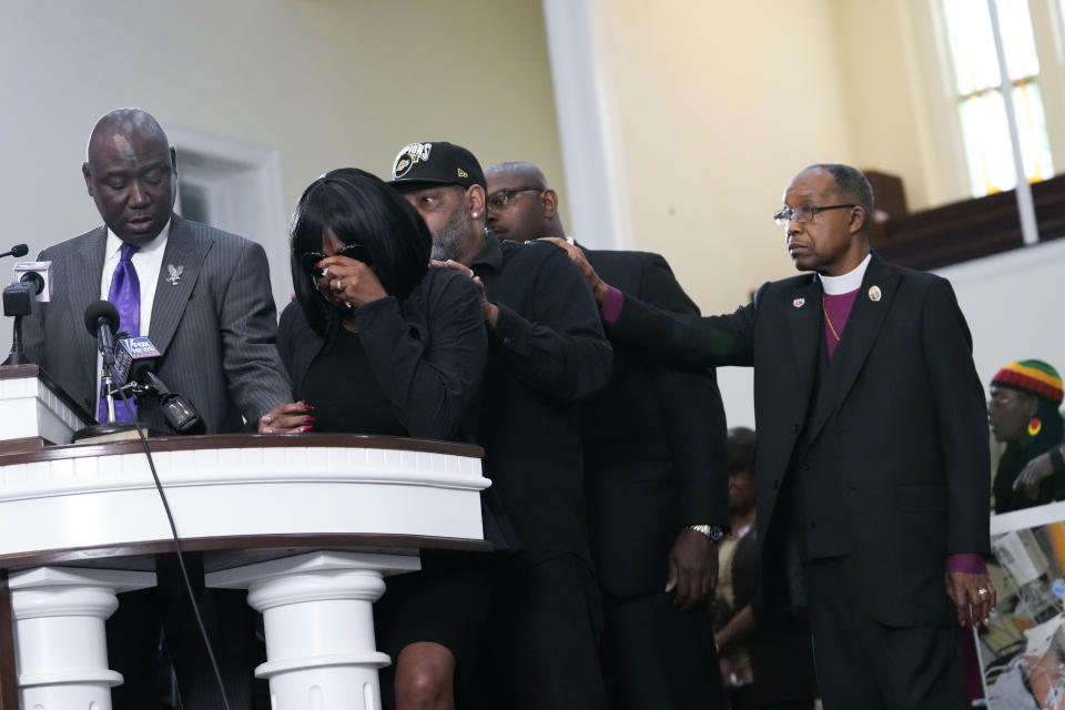 RowVaughn Wells, second from left, mother of Tyre Nichols, who died after being beaten by Memphis police officers, cries as she is comforted by Tyre's stepfather Rodney Wells, behind her, at a news conference with civil rights Attorney Ben Crump, left, in Memphis, Tenn., Monday, Jan. 23, 2023. Far right is Bishop Henry Williamson. (AP Photo/Gerald Herbert)