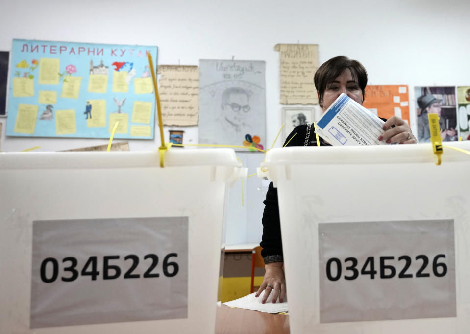 A woman casts her ballot for a general election at a poling station in the Bosnian town of Banja Luka, 240 kilometers (149 miles) northwest of Sarajevo, Sunday, Oct. 2, 2022. Polls opened Sunday in Bosnia for a general election that is unlikely to bring any structural change despite palpable disappointment in the small, ethnically divided Balkan country with the long-established cast of sectarian political leaders. (AP Photo/Darko Vojinovic)