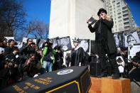 <p>Protesters listen to the eulogy by Chris Chapman over the presidential coffin at the “Mock Funeral for Presidents’ Day” rally at Washington Square Park in New York City on Feb. 18, 2017. (Gordon Donovan/Yahoo News) </p>