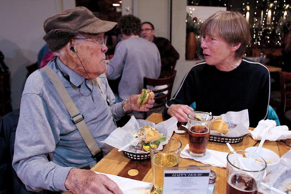 Charles Britton, left, a 101-year-old Fort Collins resident, enjoys a burger and conversation with his daughter-in-law, Katherine Britton, at Choice City on Feb. 8 in Fort Collins.