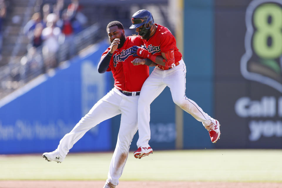 Cleveland Indians' Amed Rosario, right, celebrates with Franmil Reyes after hitting a game winning single off Chicago Cubs pitcher Keegan Thompson during the tenth inning of a baseball game, Wednesday, May 12, 2021, in Cleveland. The Indians defeated the Cubs 2-1. (AP Photo/Ron Schwane)