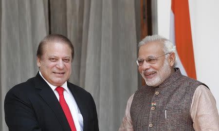 India's Prime Minister Narendra Modi (R) and his Pakistani counterpart Nawaz Sharif smile in New Delhi May 27, 2014. REUTERS/Adnan Abidi/Files