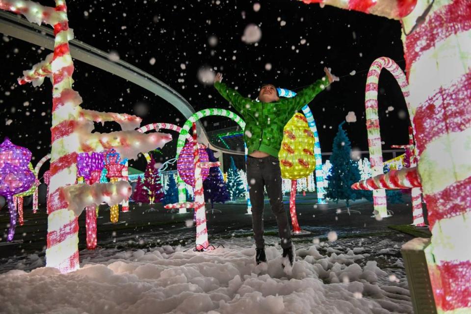 Joshua Tejada, 8, of Redding, plays in bubbles floating in the air near the candy cane display at the Imaginarium at the Cal Expo in Sacramento in 2022.