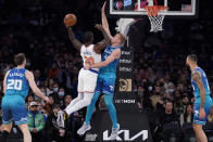 New York Knicks forward Julius Randle (30) shoots against Charlotte Hornets center Mason Plumlee (24) during the first half of an NBA basketball game, Monday, Jan. 17, 2022, in New York. (AP Photo/John Minchillo)