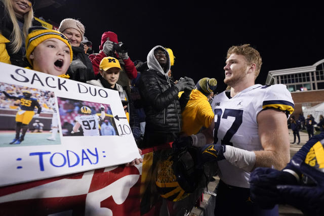 Michigan defensive end Aidan Hutchinson talks to fans after an NCAA college football game against Maryland, Saturday, Nov. 20, 2021, in College Park, Md. Michigan won 59-18. (AP Photo/Julio Cortez)