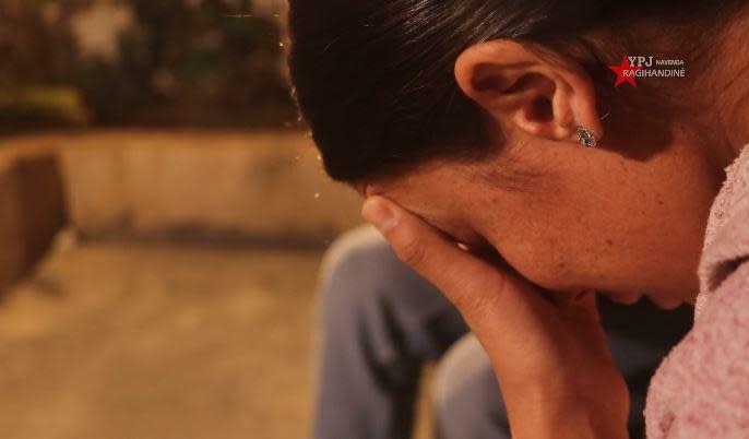 Wafaa Ali Abbas, an ethnic Yazidi who was abducted from her village in northwest Iraq by ISIS militants in 2014, speaks with her father and other family members for the first time after being rescued from captivity in the Al-Hol refugee camp in Syria, in early September 2022. / Credit: Handout/YPJ