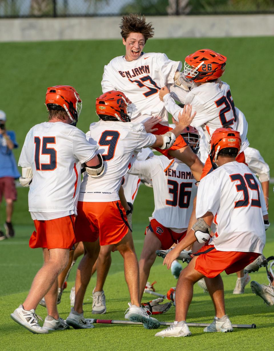 Gavin Gelinas (37) of The Benjamin School celebrates with teammates after winning the Class 1A state championship game over Community School of Naples in Naples on Saturday evening, May 11, 2024. Photo by Darron R. Silva