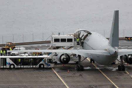 An injured German tourist involved in a bus accident is helped onto a German Air Force medical airplane at Cristiano Ronaldo Airport in Funchal, on the island of Madeira, Portugal April 20, 2019. REUTERS/Rafael Marchante