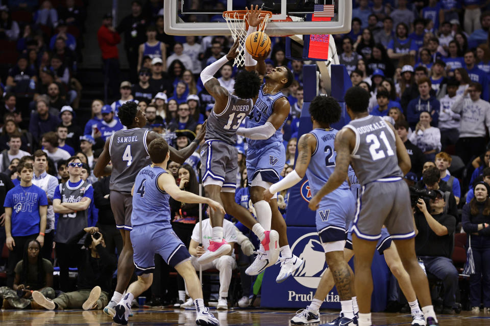 Villanova forward Eric Dixon blocks a shot by Seton Hall forward KC Ndefo (13) during the first half of an NCAA college basketball game, Tuesday, Feb. 28, 2023, in Newark, N.J. Villanova won 76-72. (AP Photo/Adam Hunger)