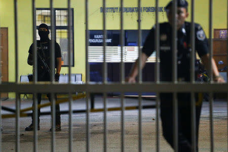 Police stand guard at the gate of the morgue at Kuala Lumpur General Hospital where Kim Jong Nam's body is held for autopsy in Malaysia, February 21, 2017. REUTERS/Athit Perawongmetha
