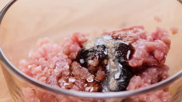 Minced pork and marinade ingredients in a bowl