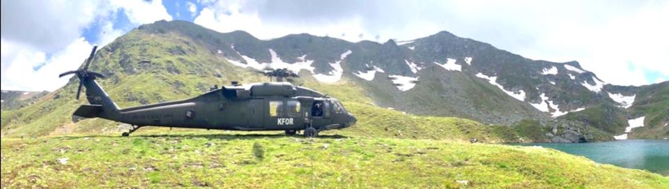 A Black Hawk helicopter from Company A, 1/126, against the terrain of Kosovo.