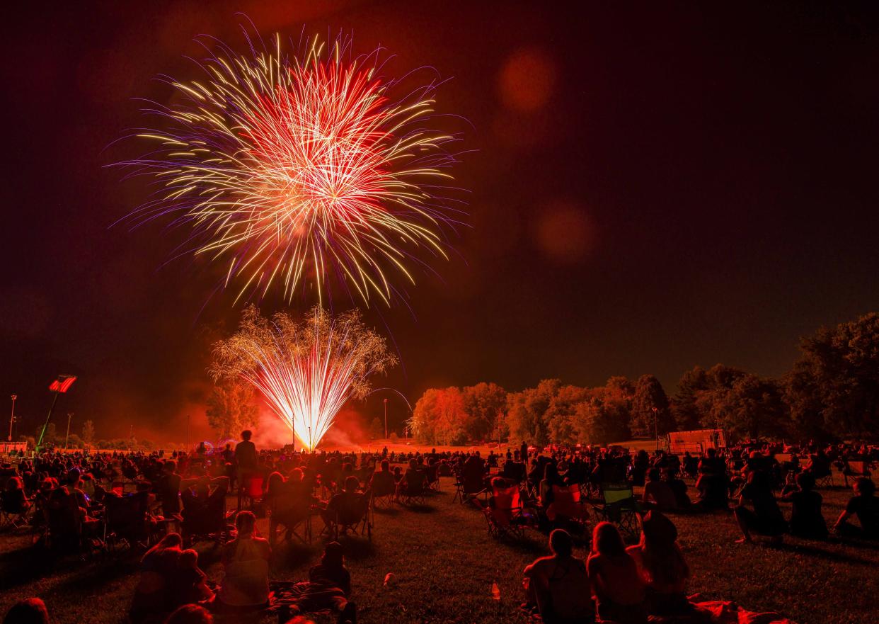 A large crowd watches fireworks at the Monroe County Fairgrounds in Bloomington, Ind.