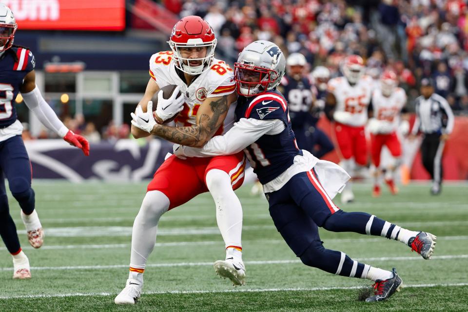 Kansas City Chiefs tight end Noah Gray is tackled by New England Patriots cornerback Jonathan Jones during a game earlier this season.