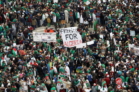 FILE PHOTO: Demonstrators hold banners as they return to the streets to press demands for wholesale democratic change well beyond former president Abdelaziz Bouteflika's resignation, in Algiers, Algeria April 19, 2019. REUTERS/Ramzi Boudina/File Photo