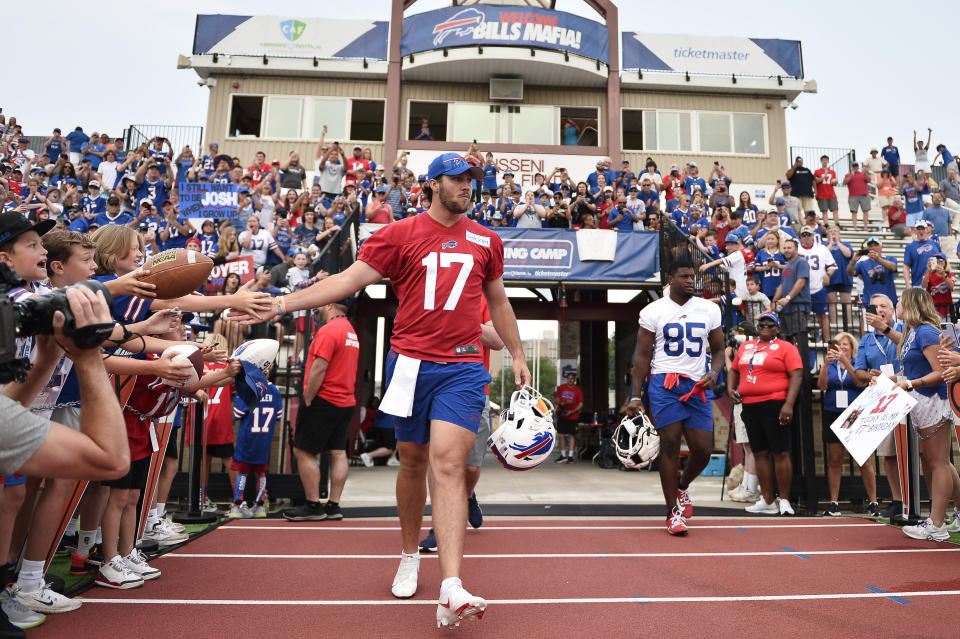 FILE - Buffalo Bills quarterback Josh Allen (17) walks to the field before practice at the NFL football team's training camp in Pittsford, N.Y., Wednesday, July 26, 2023. Allen has become accustomed to having his public life picked over and documented with his star status in Buffalo and beyond showing no signs of cresting. (AP Photo/Adrian Kraus, File)