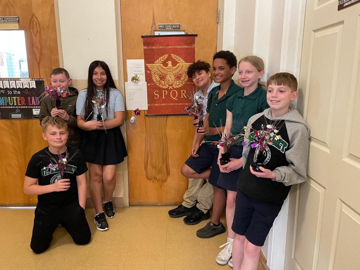 Fifth and sixth grade students from St. Benedict's with their awards from the International Exploratory Latin Exam.