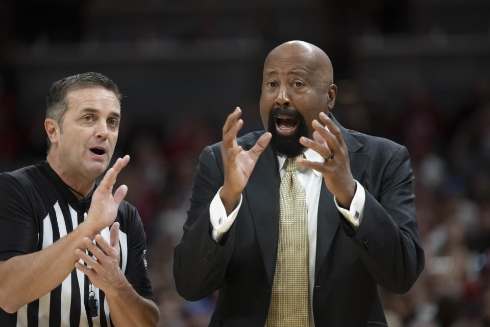 Indiana head coach Mike Woodson, right, talks with a referee during the first half of an NCAA college basketball game against Miami (Ohio), Sunday, Nov. 20, 2022, in Indianapolis. (AP Photo/Marc Lebryk)