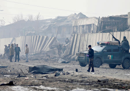 FILE PHOTO: Afghan security forces inspect the site of a car bomb blast at green village in Kabul, Afghanistan January 15, 2019. REUTERS/Mohammad Ismail/File Photo