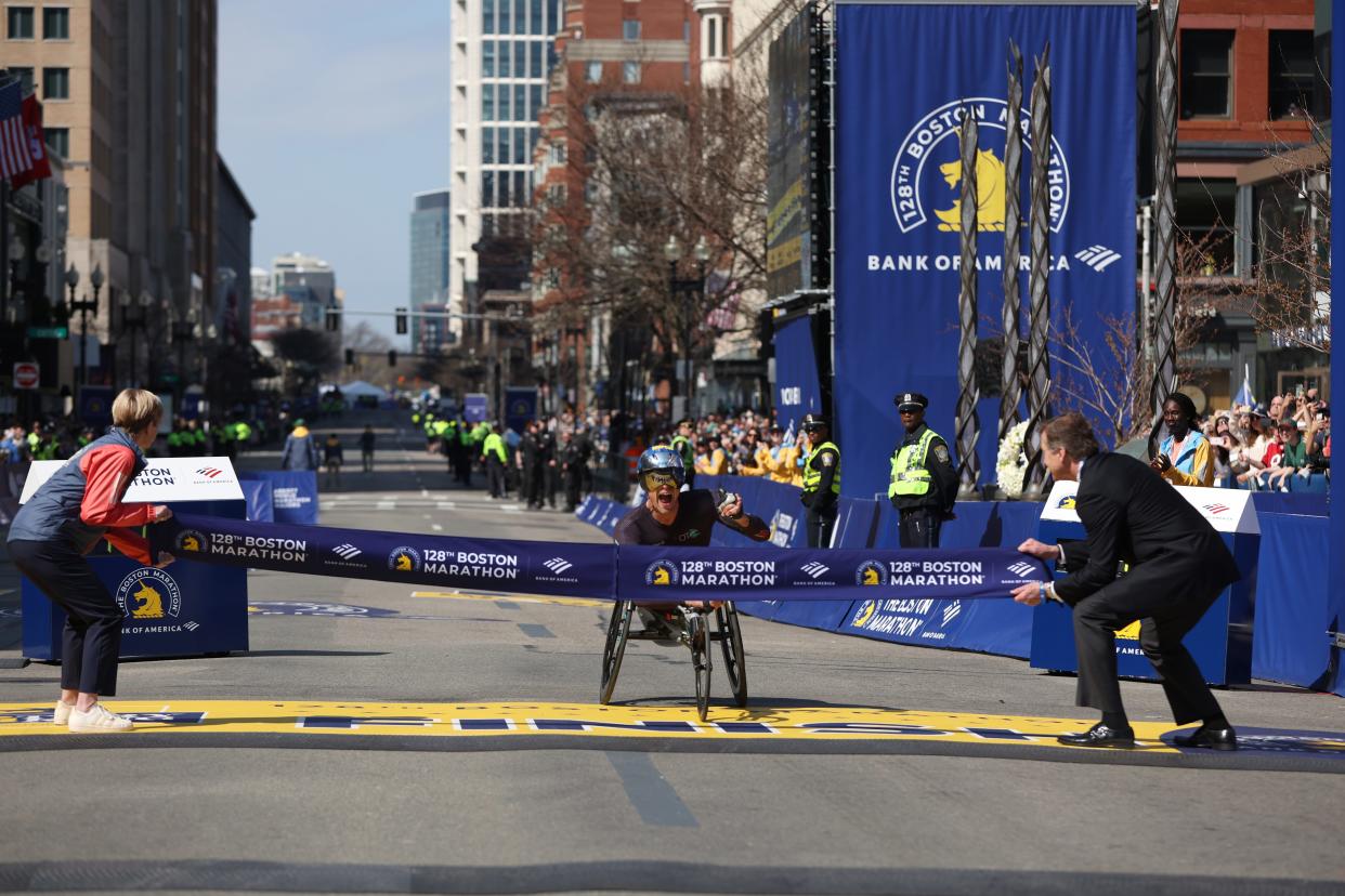 Marcel Hug of Switzerland crosses the finish line to win the Professional Men's Wheelchair Division at the 128th Boston Marathon on April 15, 2024, in Boston, MA.