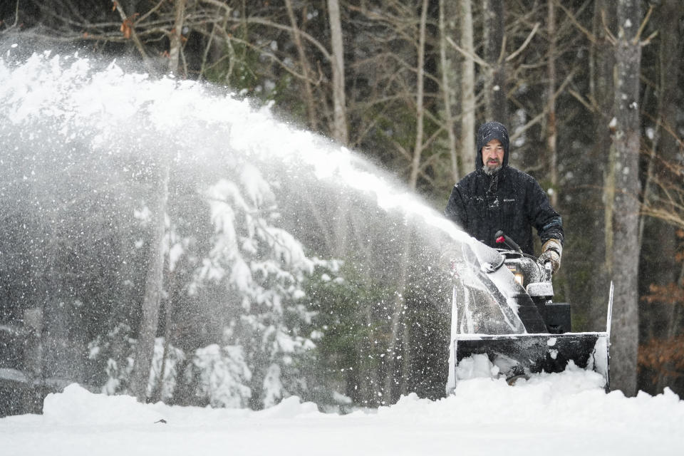 Jim Long uses his snow blower 