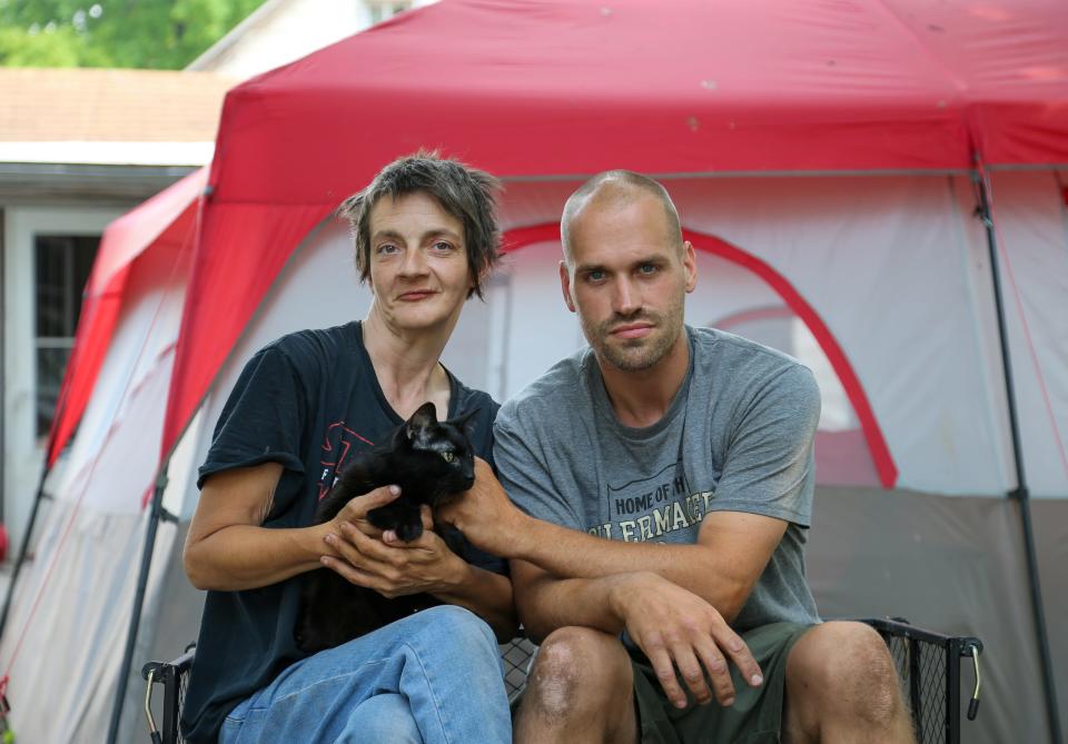 Angela Moody and Randall Tanksely take a break from cleaning out the backyard of the property they were evicted from Chaofeng Liu, an adjunct professor at Purdue University in the Department of Statistics, on Monday, June 5, 2023, in Lafayette, Ind.