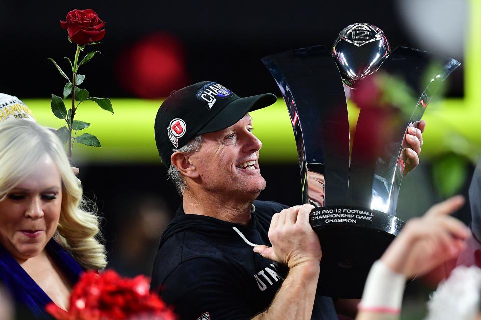 Kyle Whittingham holds up the Pac-12 championship trophy after Utah's victory over Oregon in December.