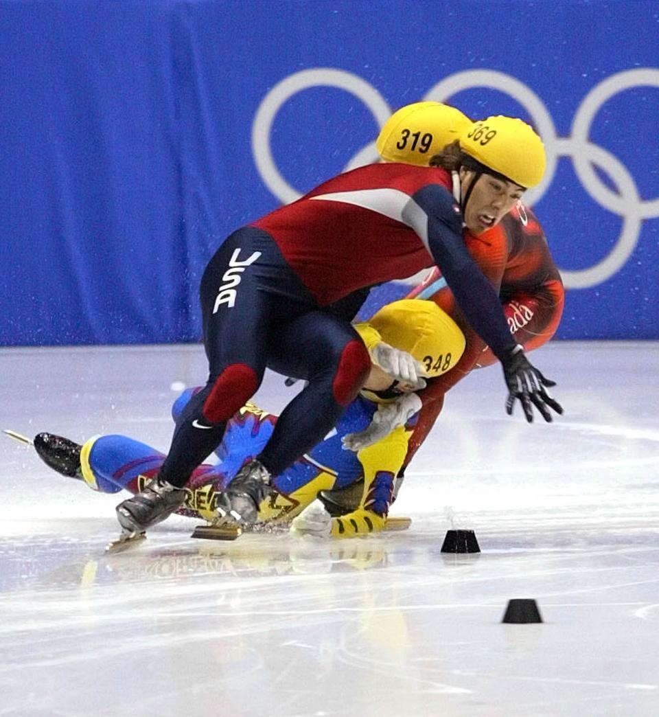 USA’ s Apollo Ohno tangles and crashes on the last turn of the men’s 1,000 meter short-track speedskating Saturday, Feb. 16, 2002, at the Salt Lake Ice Center. Behind Ohno is Korea’s Hyun-Soo Ahn and Canada’s Mathieu Turcotte. Australia’s Steven Bradbury won the gold. Ohno took the silver. | Chuck Wing, Deseret News