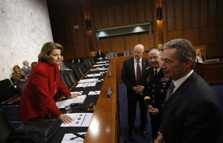 U.S. Senate (Select) Intelligence Committee Chairwoman Dianne Feinstein (D-CA)(L) speaks with Director of National Intelligence James Clapper (2nd L), National Security Agency Director General Keith Alexander and Deputy Attorney General James Cole (R) before they testify at a Senate Intelligence Committee hearing the Foreign Intelligence Surveillance Act legislation on Capitol Hill in Washington, September 26, 2013. REUTERS/Jason Reed