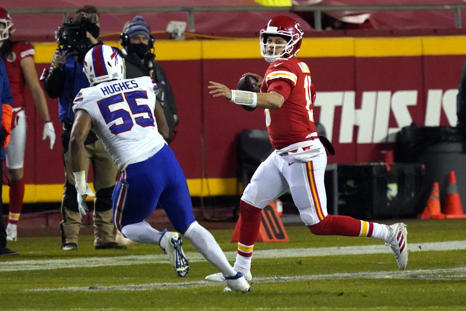 Kansas City Chiefs quarterback Patrick Mahomes is pressured by Buffalo Bills defensive end Jerry Hughes (55) while throwing a pass during the first half of the AFC championship NFL football game, Sunday, Jan. 24, 2021, in Kansas City, Mo. (AP Photo/Jeff Roberson)