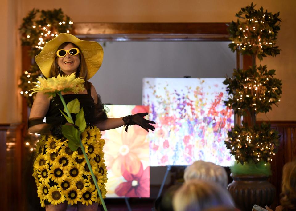 Amy Zelle models the sunflower in the Massillon Woman's Club Daffodil Luncheon 2022 Floral Fantasy - The Language of Flowers. The fashion show focused on how flowers sent different messages during Victorian times.